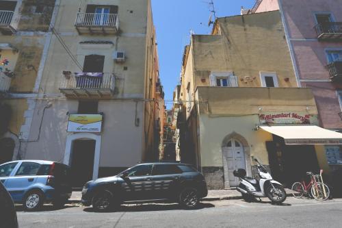 a car and a motorcycle parked in front of buildings at IL VIAGGIATORE VIA INDIPENDENZA B&B in Gaeta
