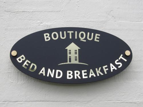 a sign on a wall that reads boutique red and breakfast at The Townhouse in Perth