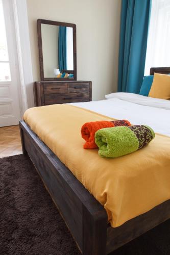 a bed with two pillows sitting on top of it at Great Central Apartment in Sibiu