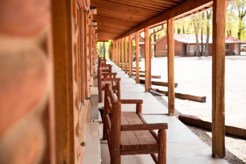 a row of wooden benches sitting on a building at The Longhorn Ranch Resort Lodge & RV Park in Dubois
