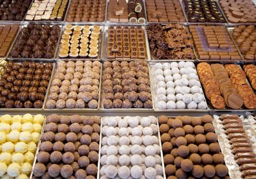 a display of different types of donuts in a bakery at Hotel National in Frutigen