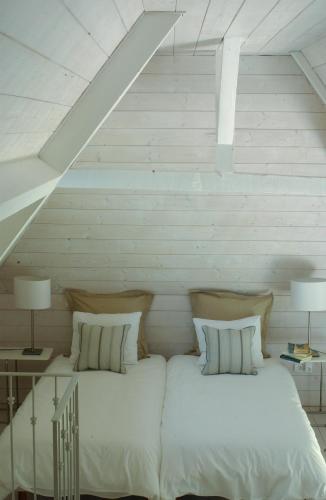 a bed with white sheets and pillows in a room at Clos Mirabel Manor - Holiday rental in Jurançon