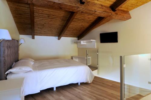 a bedroom with a bed and a flat screen tv at Plaza Sandra in Trujillo