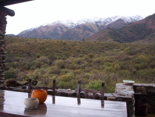 a pumpkin sitting on a table with a view of a mountain at Verde Niña Casas Serranas in Cortaderas