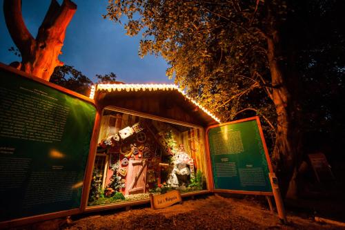 une exposition d'une maison avec des lumières de Noël dans l'établissement Przystanek Bavaria - Sauny, parking oraz wstep do Parku Bajek w cenie!, à Karpacz