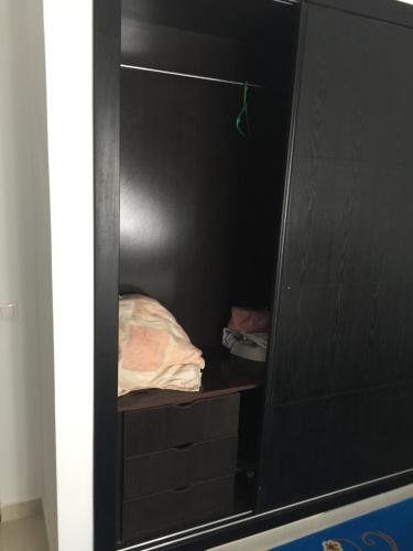 a closet with a black wall and a shelf at Appartement De Luxe A Wilaya De Tetouan in Tetouan
