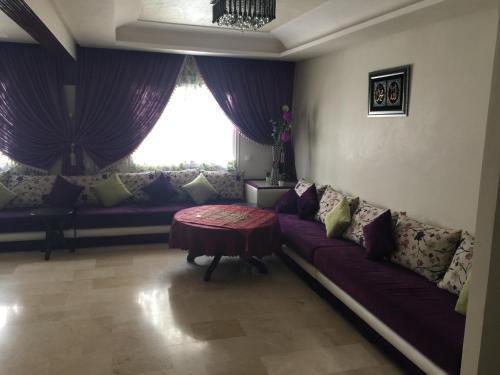 a living room with a couch and a table at Appartement De Luxe A Wilaya De Tetouan in Tetouan