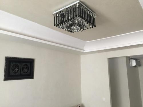 a chandelier hanging from a ceiling in a room at Appartement De Luxe A Wilaya De Tetouan in Tetouan
