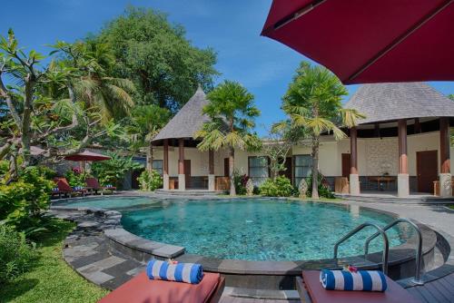a swimming pool in front of a villa at Kadiga Villas Ubud by GenuineHost in Ubud