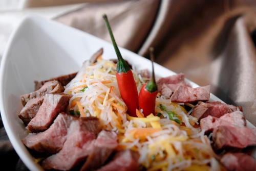 a plate of food with meat and cheese at Hotel National in Frutigen