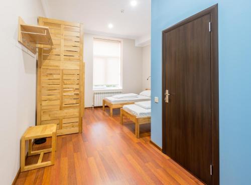 a small room with a bed and a door at SAHIL Hostel & Hotel in Baku