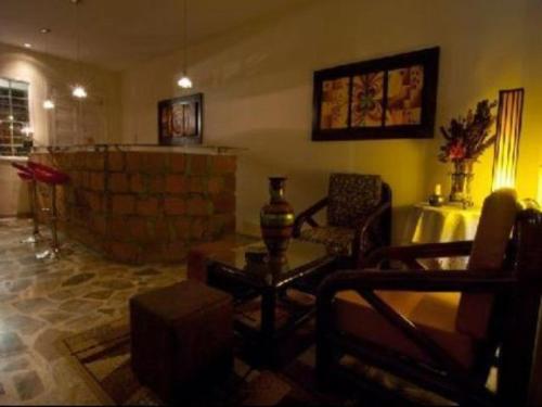 a living room filled with furniture and a table at 61Prado Hotel in Medellín