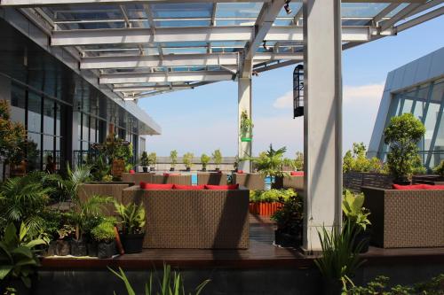 arium of an office building with plants at Swiss-Belhotel Cirebon in Cirebon