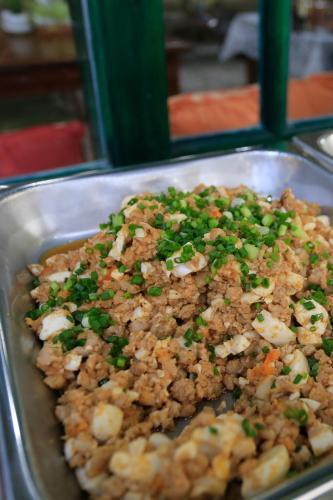 a tray of food withpared food in a pan at Anchan Laguna Hotel โรงแรมอัญชันลากูน่า in Khon Kaen