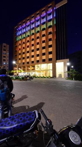 a motorcycle parked in front of a building at night at Hotel H - Sandhill Hotels Private Limited in Anand