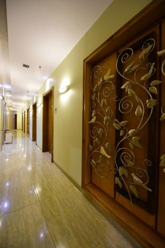 a hallway with a wall art in a hotel room at Hotel H - Sandhill Hotels Private Limited in Anand