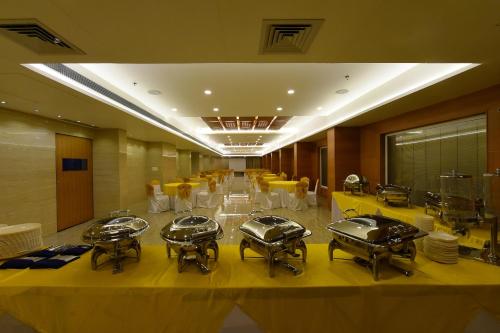 a row of drums in a room with yellow chairs at Hotel H - Sandhill Hotels Private Limited in Anand