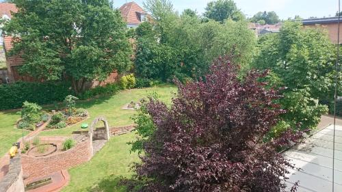 an aerial view of a garden with purple flowers at Hotel & Auberge le Journal in Sankt Wendel