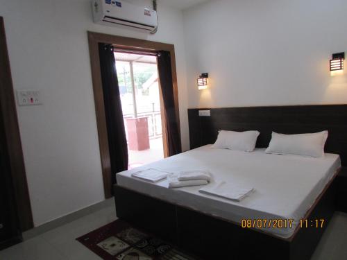 ein Schlafzimmer mit einem Bett mit zwei Handtüchern darauf in der Unterkunft Hotel Vrindavan in Fatehpur Sīkri