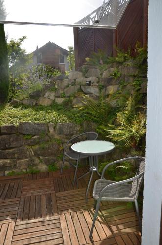 a table and two chairs on a wooden deck at BnB chez Fanfan in Morges