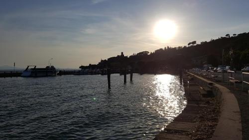 a body of water with the sun in the sky at Orto degli Ulivi in Sinalunga