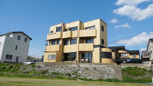 a wooden building with windows on the side of it at sararaso in Kanazawa