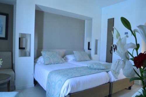 a bedroom with a large bed with blue walls at Club Palm Azur Families and Couples in Midoun