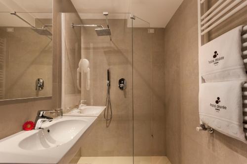 a bathroom with a sink and a glass shower at Hotel Désirée - Garda Lake Collection in Sirmione
