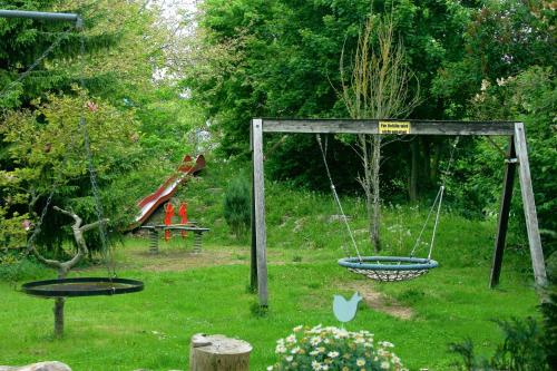 a swing in a yard with a playground at Gästehaus am Wasserpark in Rust