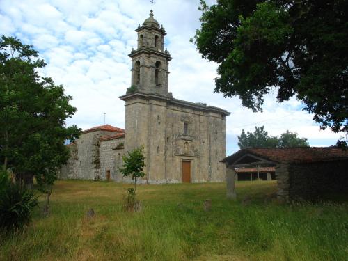 an old church with a clock tower on top of it at Casa de las Flores Sober Ribeira Sacra in Sober