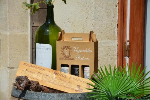a bottle of wine and a box of wine bottles at Vignobles Fabris in Saint-Émilion