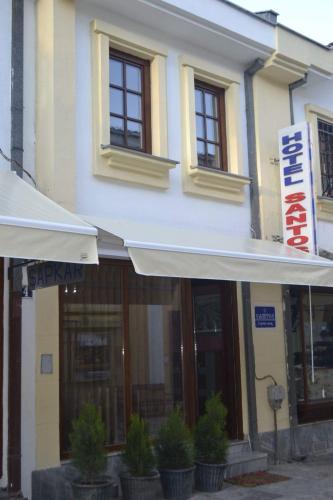 a building with a sign on the side of it at Hotel Santos in Skopje