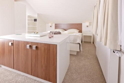 a bedroom with a bed with a white counter and a bed at Restaurant Niedmühle Land & Genuss Hotel in Rehlingen-Siersburg