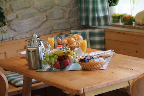 a wooden table with a tray of fruit and juice at Gästehaus Walpurga in Russbach am Pass Gschütt