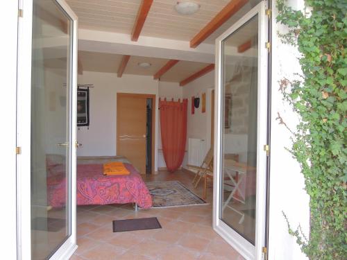 a bedroom with a bed and a sliding glass door at Casa Solotti in Nuoro