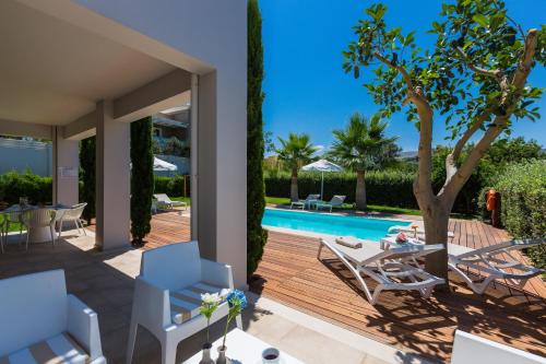 a villa with a swimming pool and a patio at Aria Villas - Private Pool, Playground, Ping Pong & Close to Beach, By ThinkVilla in Pigi