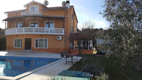 a house with a swimming pool in front of it at Apartments Šeherzada in Pula