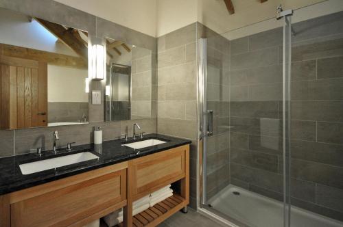 a bathroom with two sinks and a shower at The Barn at Ballaloaghtan in Ballasalla
