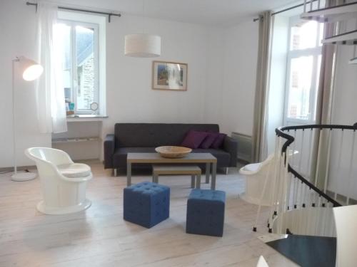 a living room with a couch and a table at La Maison Bellevue in Saint-Efflam