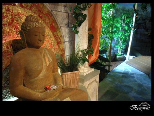 a statue of a buddha sitting on the ground at Hotel Bergwirt in Herrieden