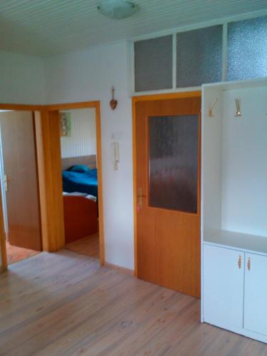 a room with a door and a bedroom with a bed at Apartment Janja in Vojnik