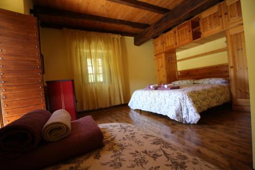 a bedroom with two beds and a large window at Agriturismo Cà Sonino in Bettola