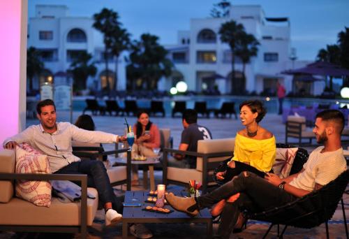 a group of people sitting in chairs in a patio at Pullman Mazagan Royal Golf & Spa in El Jadida
