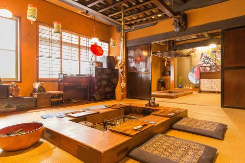 a kitchen with a stove in the middle of a room at Irorinoyado Ashina in Aizuwakamatsu