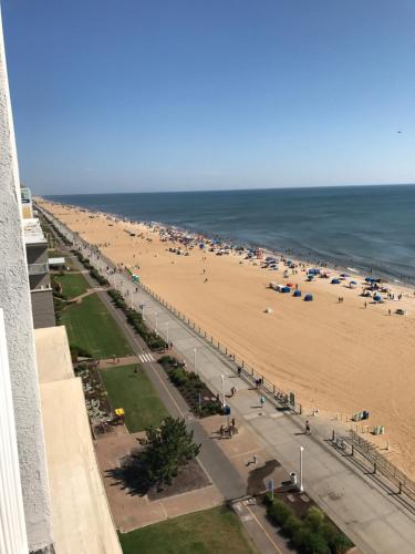 a view of the beach from the balcony of a building at Sun & Sand Resort Oceanfront Suites in Virginia Beach