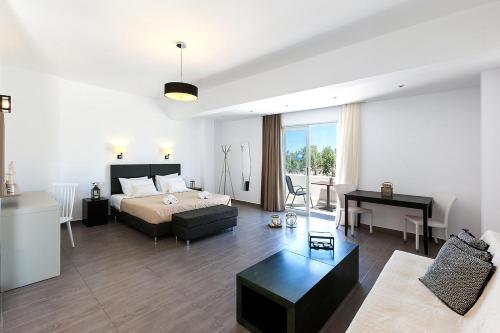 a bedroom with a bed and a living room at Memories Beach Hotel in Monolithos
