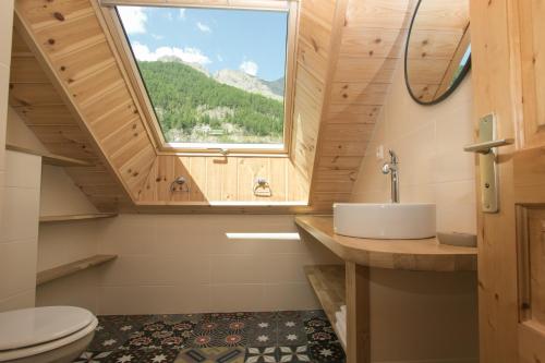a bathroom with a sink and a window at La Baïta Du Loup in Saint-Véran
