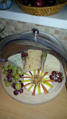 a plate of cheese and grapes on a table at Hotel Alpin Murau in Murau
