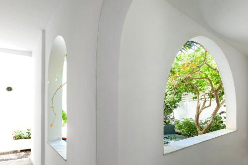 two mirrors on the wall of a room with white walls at Memories Beach Hotel in Monolithos