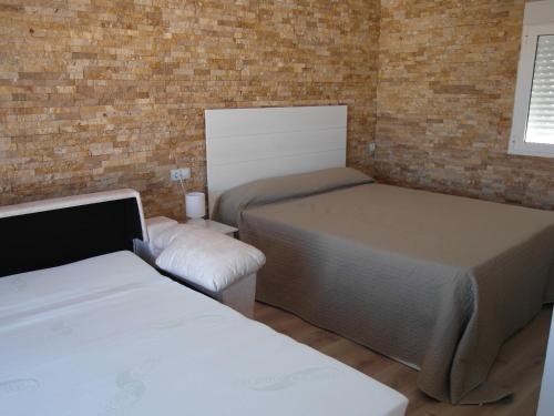 Llit o llits en una habitació de Apartamento Sol del Mar